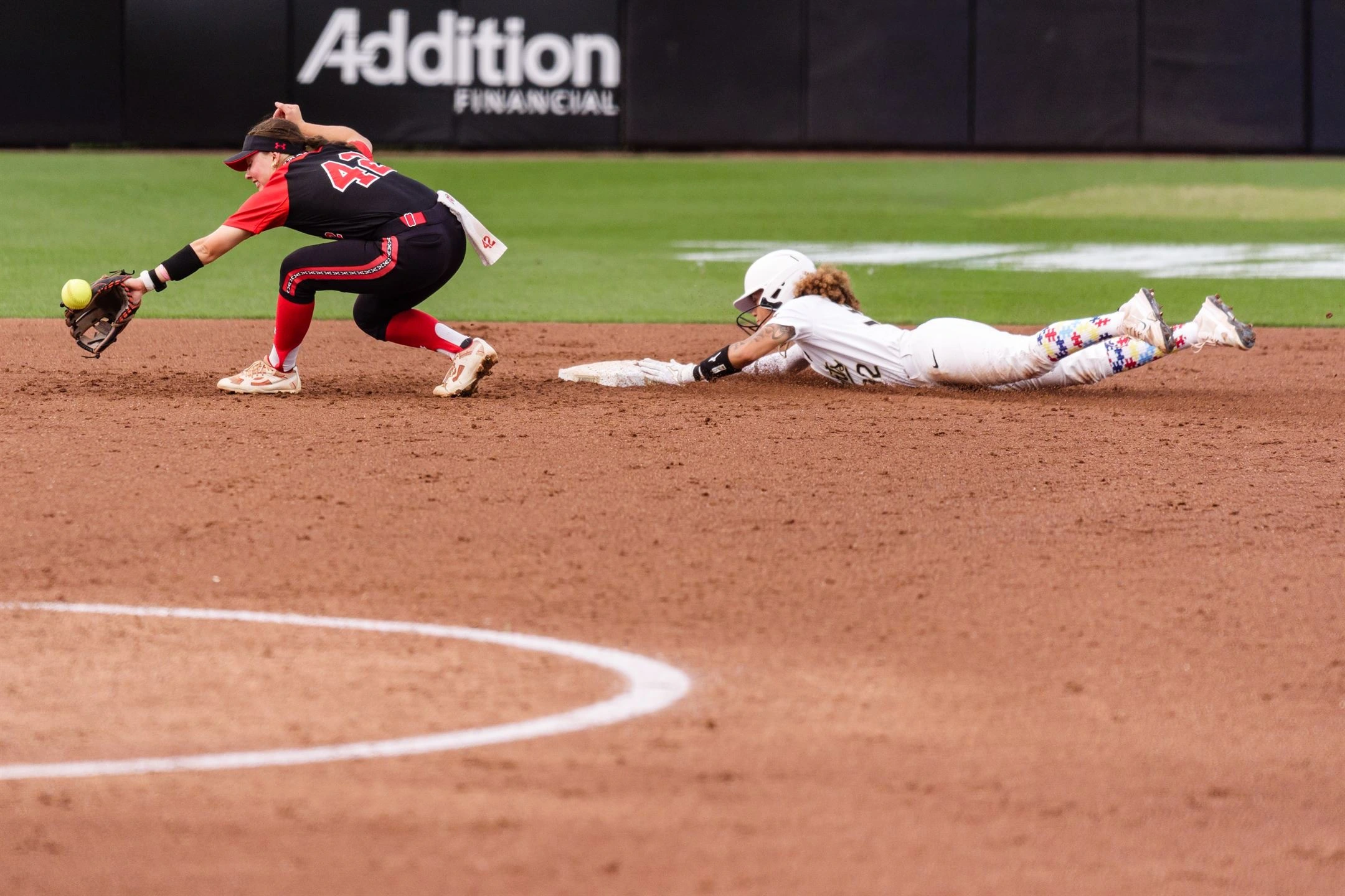 Zoe Calvez diving headfirst into second base ahead of the tag